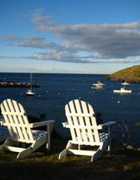 The spacious porch and yard of the Island Inn is a comfortable meeting spot, overlooking the harbor. Photos by Bob and Kim Schutsky